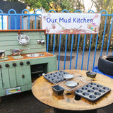 Designed for outdoor play areas, the Our Mud Kitchen banner is made of heavy duty weatherproof vinyl and comes with brass eyelets so it can be easily hung outside. Useful to designate play areas in preschool, nurseries and primary school playgrounds. Available in 2 sizes.